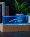 Ocean Scene Resin Night Light With Wood Base Usb Powered Lamp with humpback whale in blue resin and diver on nightstand.