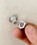 Pro Grade Threaded Concrete Nails With M8 Nut Caps Hardcore Hammer Set Fasteners showing threaded nail and nut in hand.