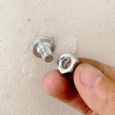 Pro Grade Threaded Concrete Nails With M8 Nut Caps Hardcore Hammer Set Fasteners showing threaded nail and nut in hand.