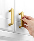 Installing 3 Inch Brushed Gold Cabinet Handles Set on white cabinet, showing rounded edges, solid metal hardware, and smooth finish.