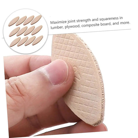 Close-up of a beech wood biscuit from 100 Pcs Wood Joining Biscuits Beech Wood Board Connection Kit For Tenon Machines And Biscuit Joiners DIY Carpentry And Woodworking Gear For Strong Joints In Furniture Framing And Projects held in hand