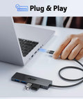 Person plugging Four Port USB 3.0 Hub With 5Gbps Transfer, Laptop And PC Extender, Power Port Enabled, into a laptop