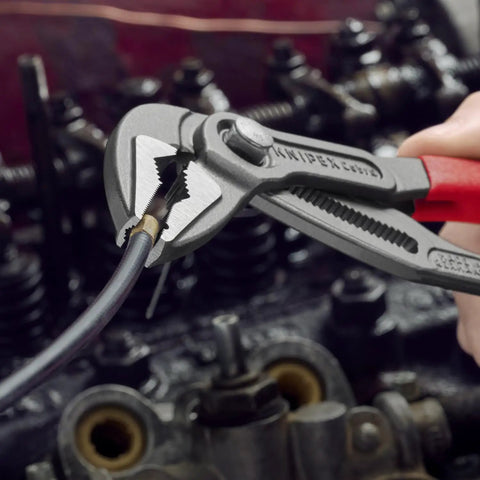 Cobra ES Extra-Slim 10 Inch Pump Pliers With Narrow Jaws gripping wire in automotive maintenance.