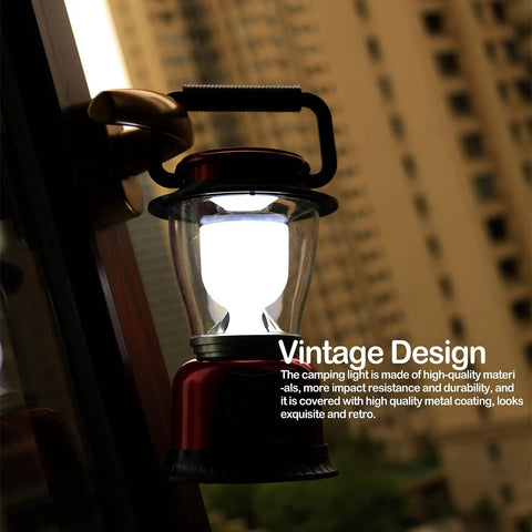 Red battery powered LED lantern with variable power for camping, dimmable COB LED light, hanging outdoors at dusk