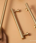 Brushed Gold Modern Kitchen Cabinet Handles Set 5 Pack Solid Brass Drawer Pulls shown lying flat on a surface