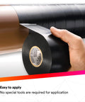 Vinyl Corrosion Protection Tape 50 Unprinted 2 In X 100 Ft Black Roll Premium Grade 10 Mil Thick High Tack All Weather RoHS Compliant For Metal Piping Systems being applied to a pipe by hand