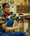 Woodworker using Cast Jaw Clamp For Woodworking And Carpentry F Style With Wood Handle, Heavy Duty Anti Slip Rail on a table.