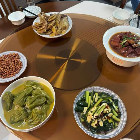 Heavy Duty Tempered Glass Lazy Susan Turntable For Dining Tables Super Slick Rotating Serving Platter 40 Inch with various dishes on it.
