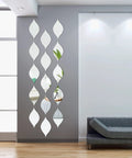 15 Pack Teardrop Mirror Wall Decals With Wavy Acrylic Finish Removable 3D DIY Art for Living Room Bathroom Home Decor 11.8 x 6.6 Inch Teardrop Silver Set arranged vertically in modern living room.