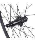 Close-up of 50mm Carbon Wheelset For Road Bikes With Tubeless Ready Clincher Rims And Rim Brake Compatibility, showing RT030 hub and spokes.