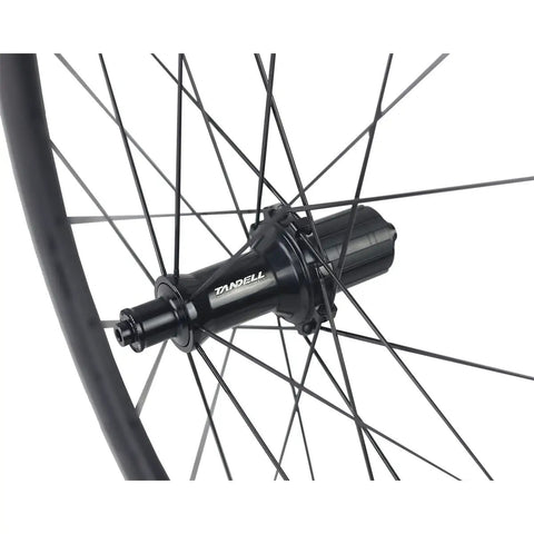 Close-up of 50mm Carbon Wheelset For Road Bikes With Tubeless Ready Clincher Rims And Rim Brake Compatibility, showing RT030 hub and spokes.