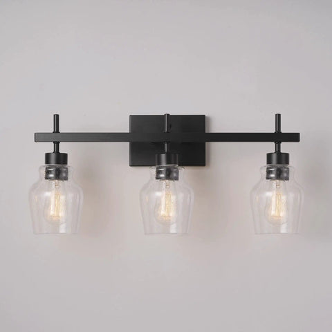 Matte black 3-light vanity fixture with seeded glass shades from 5-Piece All-In-One Matte Black Bathroom Set for modern industrial vibe.