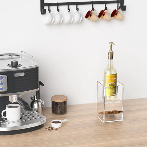 Clear acrylic Two Tier Upright Cup And Condiment Organizer with bottle and coffee machine on countertop