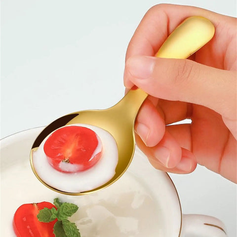 Hand holding spoon from 2 Piece Portable Fork And Spoon Set For Camping Picnics And Outdoor Dining with soup and tomato slice
