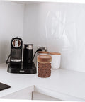 Set Of Three Airtight Glass Coffee Bean Storage Jars With Secure Screw Tops To Keep Your Loose Tea And Spice Stash Locked Down on kitchen counter.