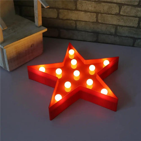 Red star shaped LED light sign with 11 warm white LEDs on a table, part of star shaped LED light sign for wall and mantel battery operated red with 11 warm white LEDs easy hanging hooks marquee decor for living room bedroom and parties ambiance