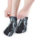 Ankle socks with witch design pulled over feet, featuring a dark cloak and hat, showcasing unique Halloween-themed style.
