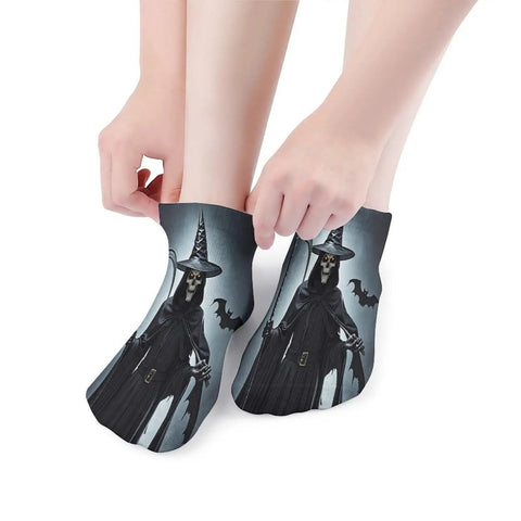 Ankle socks with witch design pulled over feet, featuring a dark cloak and hat, showcasing unique Halloween-themed style.