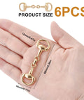 Hand holding Six Piece Set Medium Horse Bit Buckles D Ring Gold Snaffle Buckles Perfect For Women Must Have Create Exquisite Jewelry