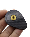 Premium Carbon Fiber Headset Top Cap Paired With Badass Gold Stainless Screws shows hand-held view of carbon fiber top cap.
