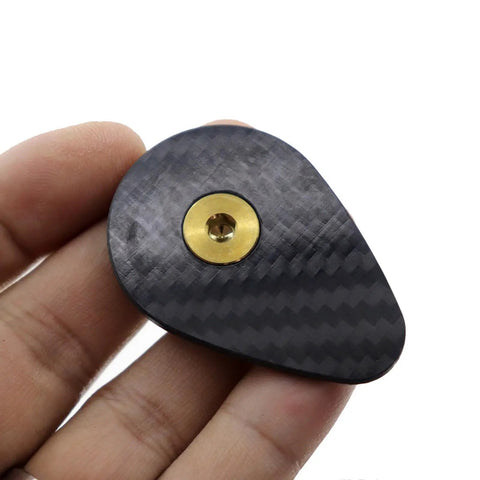 Premium Carbon Fiber Headset Top Cap Paired With Badass Gold Stainless Screws shows hand-held view of carbon fiber top cap.