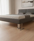 Adjustable Stainless Steel Furniture Legs 1.5 To 9.8 Inch Leveling Feet under bed on wooden floor with mounting screws visible.