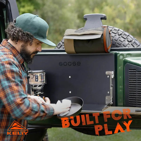 Man using Spill Ender 3 In 1 Paper Towel Holder for cars and campsites mounted on vehicle, rugged design displayed.