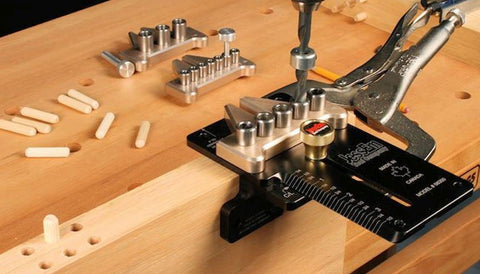 Super Handy Adjustable Doweling Jig For Spot On Three Eighth Inch Dowel Holes In Wood Projects Features One Eighth Increments Up To Three And Half Inches From Edge Durable Aluminum Build With Five Bushings Drill Bit Stop Collar Pin Included in use on wood with drill.
