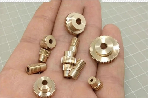 Precision 0.3 Module Worm Gear Reducer With 1 To 80 Ratio And 100 Teeth showing various brass gears in hand.