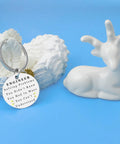 Silver engineering keychain for men with engraved text, next to white ceramic deer, gift for engineers and builders.