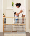 Toddler Safe Wooden Baby Gate Pressure Mount Doorway Barrier Adjustable 26 To 42 Inches Wide 23 Tall, in use preventing access.