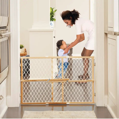 Toddler Safe Wooden Baby Gate Pressure Mount Doorway Barrier Adjustable 26 To 42 Inches Wide 23 Tall, in use preventing access.