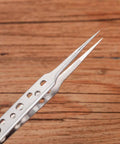 Close-up of stainless steel tweezer tip from Five Piece Stainless Steel Tweezers Set For Electronics Repair And Crafting With Anti Slip Grip Non Magnetic Tips Rust Resistant Build Pro Grade For Soldering Jewelry Making DIY Projects Tiny Parts Handling
