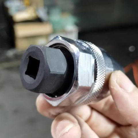 Close-up of a Damaged Bolt And Stud Extractor Tool For One Quarter Inch To One Half Inch Studs, chrome-plated, in hand.