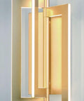 Close-up of Slick Modern Wall Sconce With Asymmetrical Fan Frame LED Light Featuring Water Mill Inspired Gold Finish.
