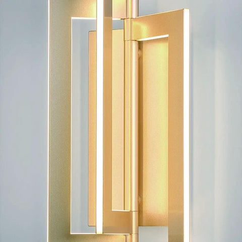 Close-up of Slick Modern Wall Sconce With Asymmetrical Fan Frame LED Light Featuring Water Mill Inspired Gold Finish.