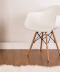 White chair on wooden floor demonstrating Plastic Self Tapping and Self Adhesive Screw Hole Covers for Wood Furniture, applied on legs.