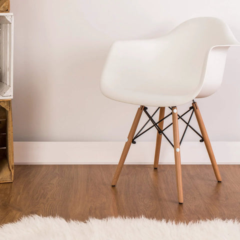 White chair on wooden floor demonstrating Plastic Self Tapping and Self Adhesive Screw Hole Covers for Wood Furniture, applied on legs.