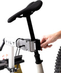 Close-up of cyclist using Bike Balance Trainer And Repair Stand Combo for core stability and bike maintenance.
