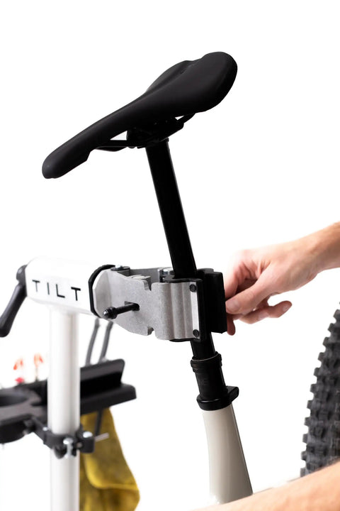 Close-up of cyclist using Bike Balance Trainer And Repair Stand Combo for core stability and bike maintenance.