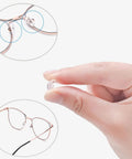 No Sweat Eyeglass Repair Kit With 18 Pairs Flexible Nose Pads demonstrated with pink frame glasses and replacement nose pad in hand.