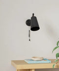 Two Pack Industrial Plug In Wall Sconces With On Off Switch Vintage Edison Swing Arm Black Metal Shade For Home Or Office 55 Inch Cord Two In One Plug In Or Hardwire mounted above a wooden table with decor