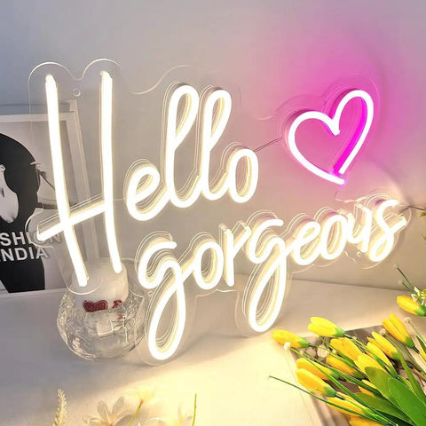 Hello Gorgeous Neon Sign For Girls Bedroom Wall Decor LED Light With Warm White Glow Perfect For Birthday Parties Weddings And Gifts 16.7x12.3 Inches Great Gift Idea displayed with flowers