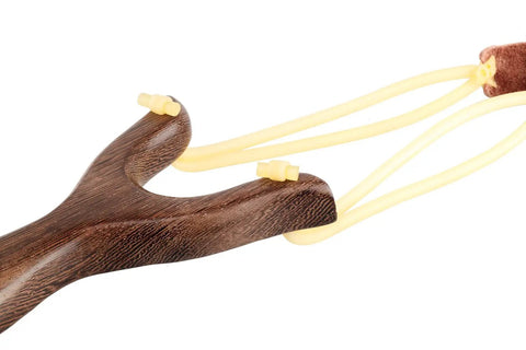 Close-up of solid wood slingshot with classic construction for adults, deep brown finish, durable rubber bands, leather ammo pocket.