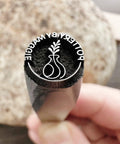 Close-up of Pro Grade Metal Signature Stamp For Jewelry And Metalwork showing crisp imprint of logo on stainless steel surface.