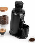 Game Changer 80 MM Flat Burr Coffee Grinder With Stepless Dial And Variable Speed Motor, black body with ground coffee.
