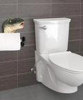 Dino Themed Toilet Paper Holder Adhesive Wall Mount in bathroom next to white toilet, kid-friendly decor with dinosaur design.