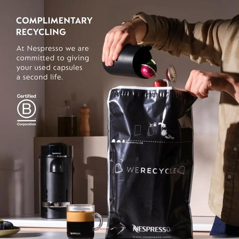 Person recycling coffee capsules with Nespresso bag next to Vertuo Pop Plus Deluxe Coffee And Espresso Maker By DeLonghi in Black Matte