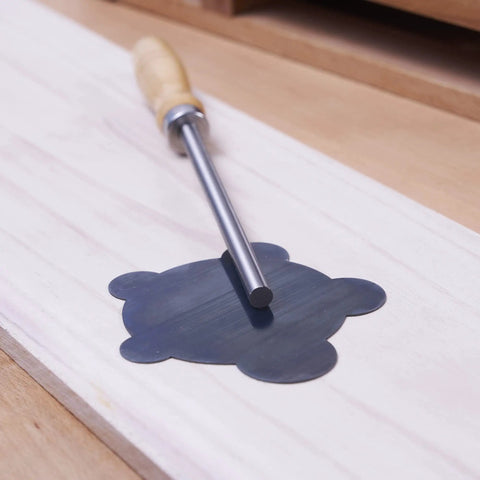 Nine Piece Cabinet Scraper Set For Woodworking With Burnisher on wooden surface, featuring curved scraper for pro grade finish