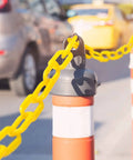 200 Ft Yellow Plastic Chain Barrier for Crowd Control and Event Decor installed on traffic cone outdoors